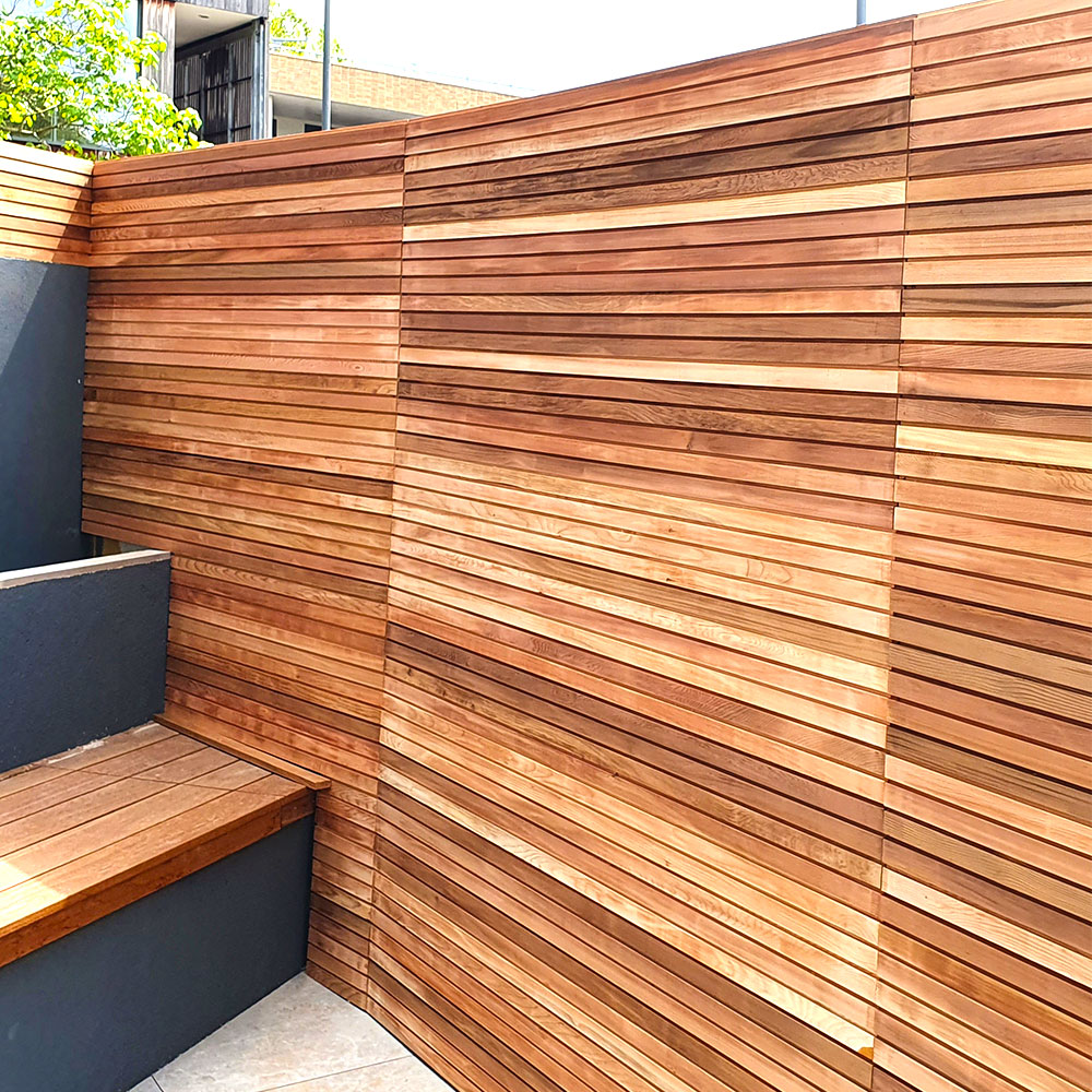 Colourful cedar privacy slim fencing panel in a courtyard