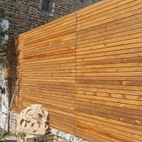 Venetian Redwood fencing on top of a wall, using our easy to configure top of wall posts!