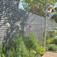 An example of an anthracite grey fence panels installed in a garden.