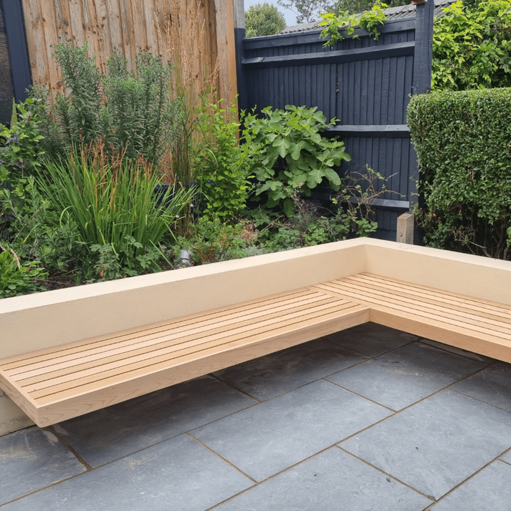 Two minimalist contemporary bench seats combined to make an L-shaped bench. Attached to the wall by seating brackets to create a "floating" bench effect.