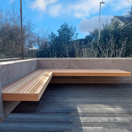 A wooden garden corner bench with a minimalist design.