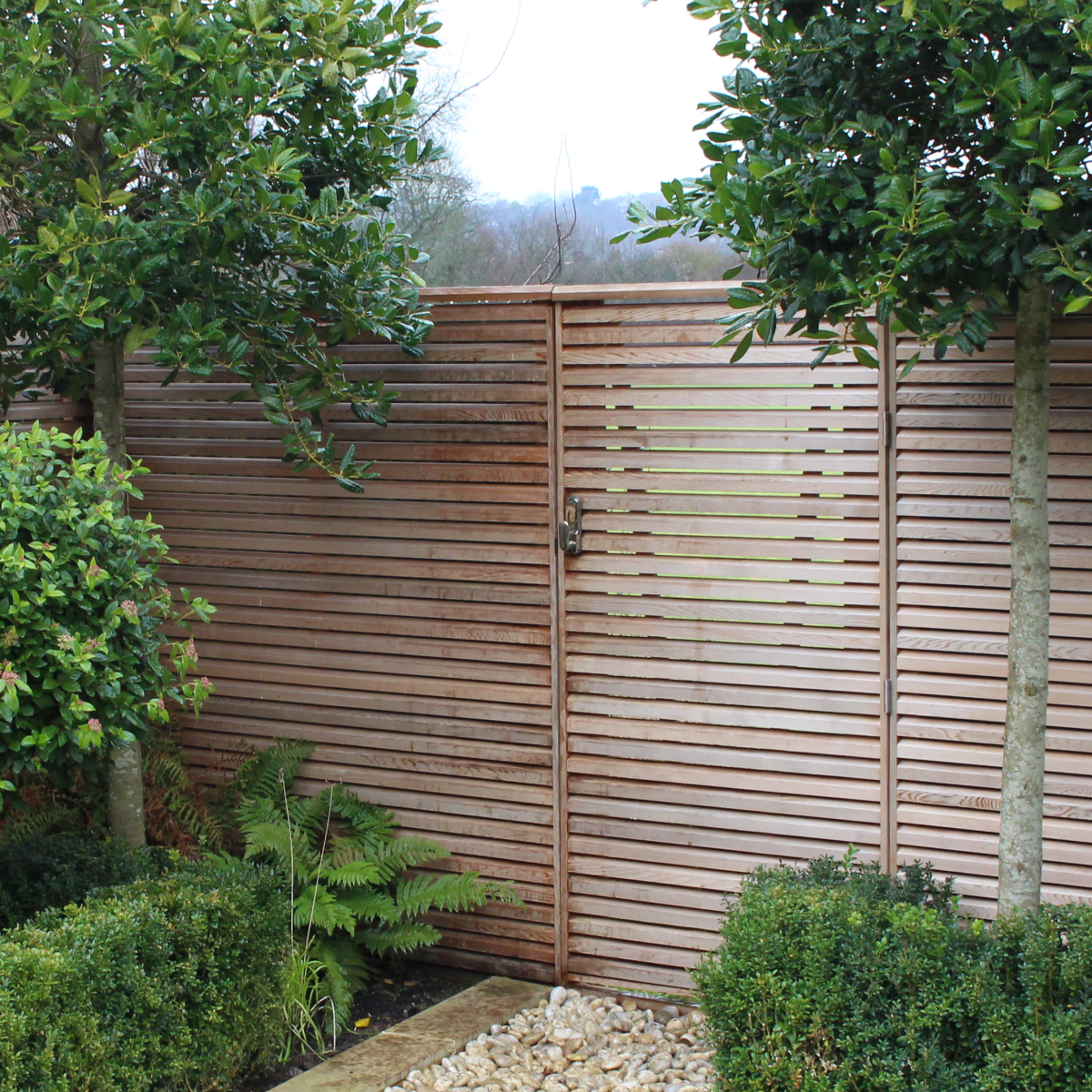 A double sided Red Cedar gate made to blend in with our Cedar fencing to give the appearance of a secret gate.