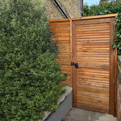 A Venetian Redwood gate with a matching Venetian Redwood fence.