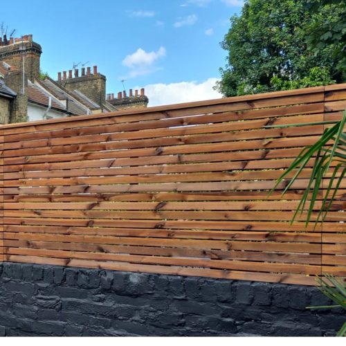 Redwood Slatted fencing on top of a garden wall