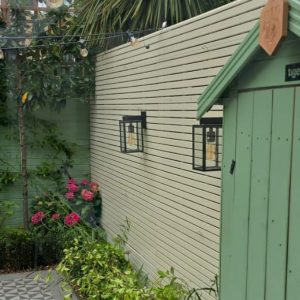 A bespoke colour painted fence in a small garden