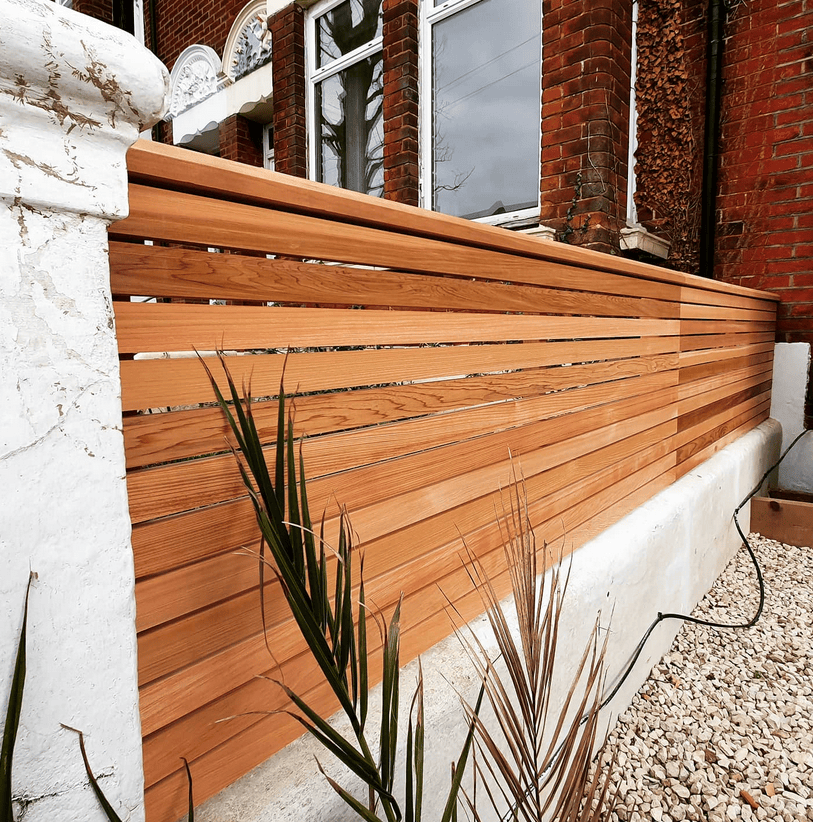 diy slatted fencing tips. A cedar fence neatly on a wall.