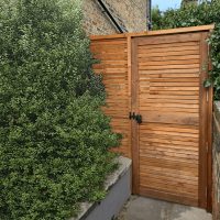 A garden gate with a black gate lock