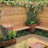 Chelsea flower show garden with larch fencing by Frogheath Landscapes