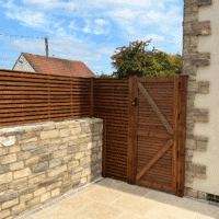 The rear of a venetian gate in a slatted hit and miss style.