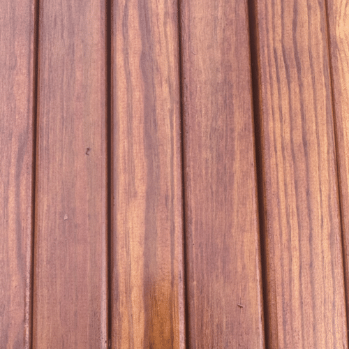 Close-up view of vertical joinery-grade redwood timber battens showing natural wood grain and eased edges.