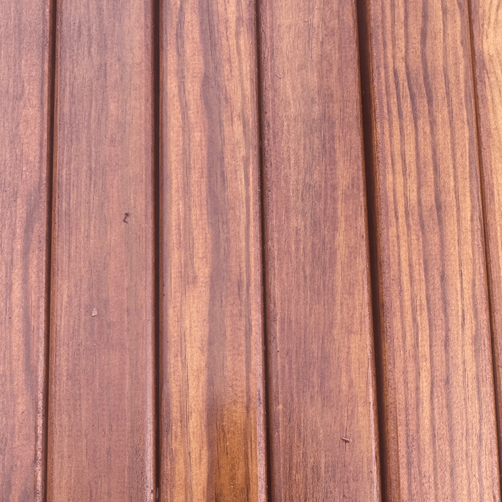 Close-up view of vertical joinery-grade redwood timber battens showing natural wood grain and eased edges.