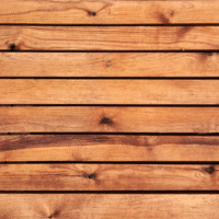 Close-up of horizontal redwood slatted fence panel showing natural timber grain and knots